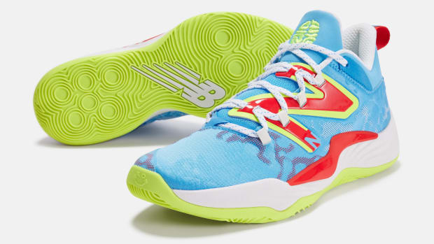 View of blue, red, and green New Balance shoes.